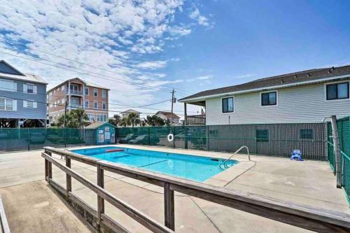 a swimming pool in front of a house at Beach Please* in Carolina Beach