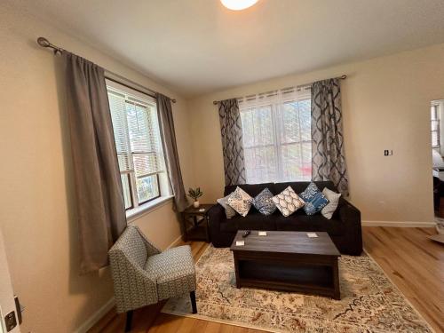 a living room with a couch and a chair at Lord Medford Apartments in Medford