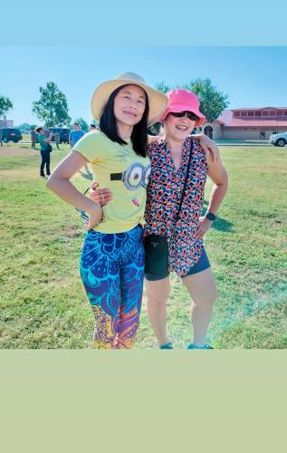 two women standing next to each other in a field at Golden Sunflower's Apt E in Lawton