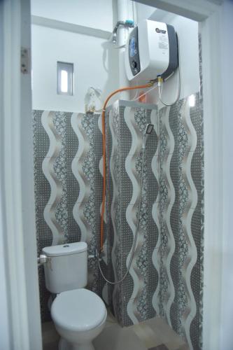 a bathroom with a toilet and a shower curtain at Toraja Dannari Homestay in Rantepao