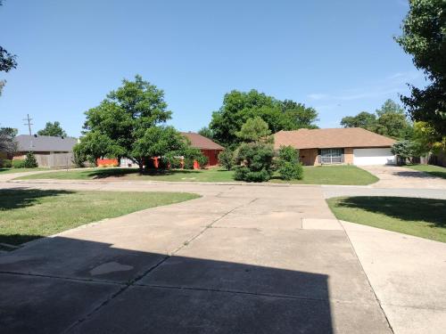 a driveway in front of a house with a house at Golden Sunflower's Apt E in Lawton