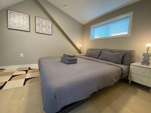a bedroom with a large bed and a window at New Modern Three-room Duplex-2793 in Vancouver