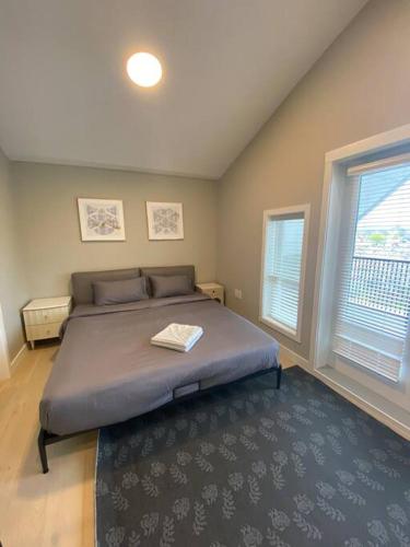 1 dormitorio con 1 cama grande con alfombra azul en New Modern Theee-room Duplex-2791 en Vancouver