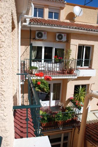 a building with flower boxes on the balconies of it at Hotel El Pozo in Torremolinos