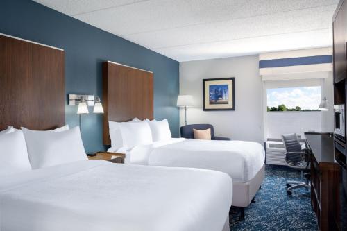 a hotel room with two beds and a television at Four Points by Sheraton Mall of America Minneapolis Airport in Richfield