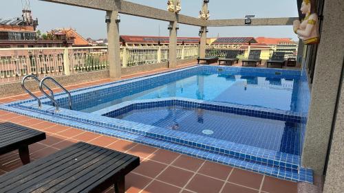 a large swimming pool on top of a building at OKAY Boutique Siem Reap in Phumi Ta Phul