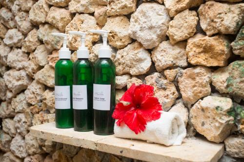 three bottles of wine sitting on a shelf next to a stone wall at Mandala Spa & Resort Villas in Boracay