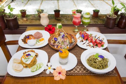 a table with plates of food and drinks on it at Mandala Spa & Resort Villas in Boracay