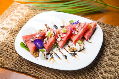 a white plate topped with watermelons on a table at Mandala Spa & Resort Villas in Boracay