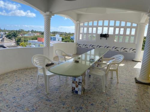 a table and chairs on a balcony with a view at Reshma appartement in Trou aux Biches