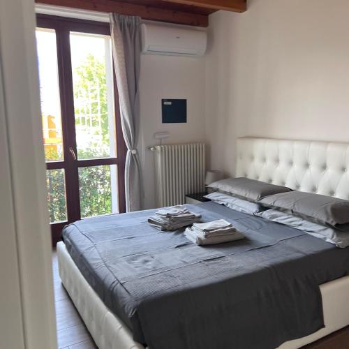 a large bed in a room with a window at VILLA LIDO - Lake Como in Colico