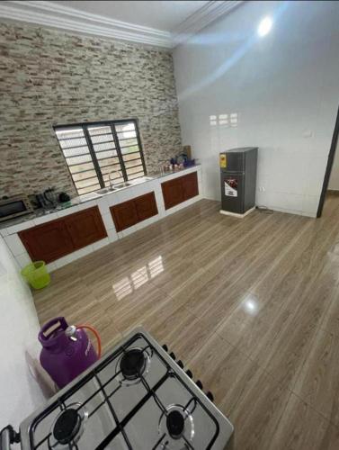 a kitchen with a stove top in a room at AGIM-GUESTHOUSSE in Abomey-Calavi