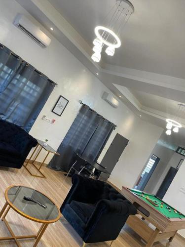 a living room with a ping pong table and chairs at AGIM-GUESTHOUSSE in Abomey-Calavi