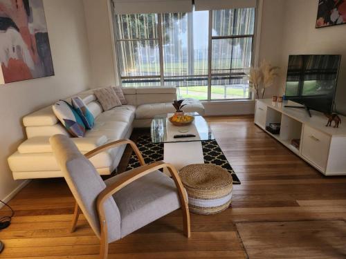 a living room with a couch and a coffee table at Blue House on Murray River in Cobram