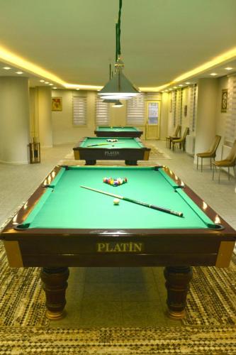 a pool table in a room with two pool tables at PİTHANA OTEL in Corum
