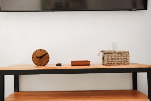 a table with a clock and a basket on it at The Volter Yogyakarta in Ngingas