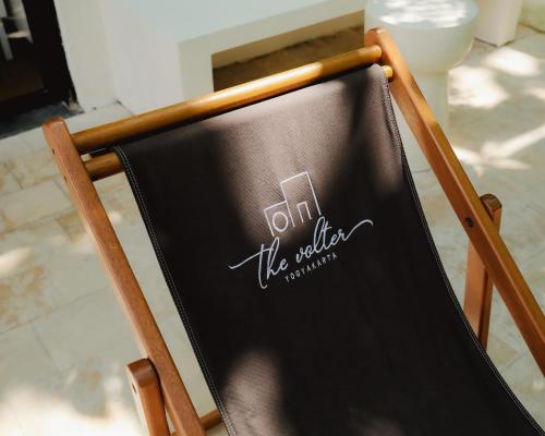 a chalkboard sign on the back of a chair at The Volter Yogyakarta in Ngingas
