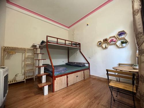 een slaapkamer met een stapelbed en een bureau bij MŨM HOMESTAY MỘC CHÂU in Mộc Châu