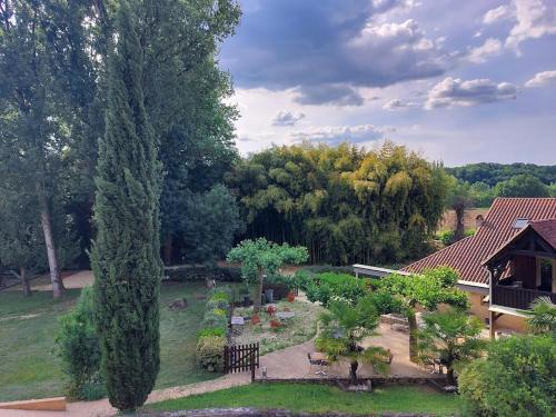 an aerial view of a garden with trees and a house at Le Moulin du Porteil in Campagne