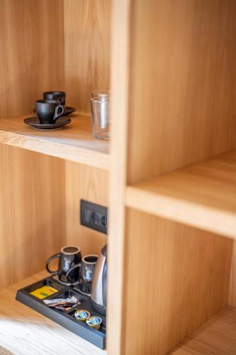 a cupboard with a coffee maker in it at Alaya Suites in Pirgos