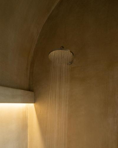 a shower with water cascading down a wall at Alaya Suites in Pirgos