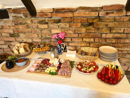a table with food and plates of food on it at Castle View in Saschiz