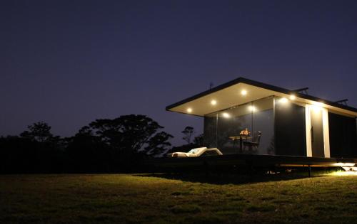 a tiny house with lights on it at night at Avion Retreat in Pumpenbill