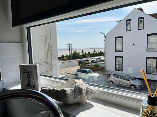 a window with a view of a parking lot at Beautiful Seafront Studio Apartment in Cleethorpes