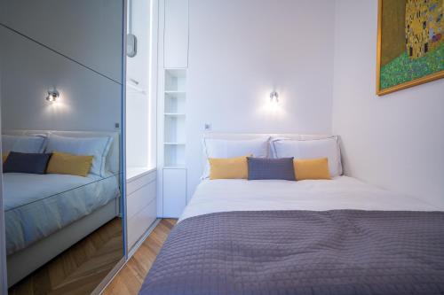 a bedroom with a large bed and a mirror at Downtown Luxury Retreat in Ljubljana
