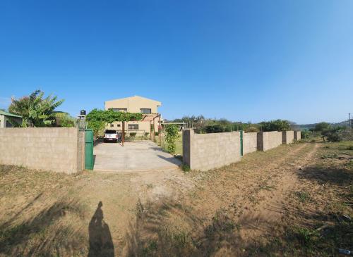 a shadow of a person standing next to a fence at CC House in Chidenguele