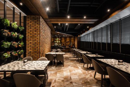 a row of tables and chairs in a restaurant at Norway Forest Motel - Wen Chuang Branch in Taichung