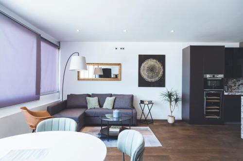 a living room with a couch and a table at Apartamento Plaza España Calle Princesa in Madrid