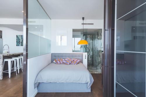 a bedroom with a bed and a glass wall at Apartamento Plaza España Calle Princesa in Madrid