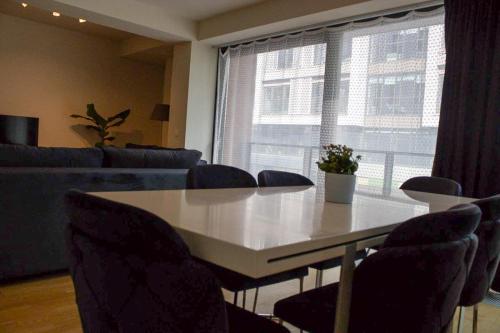 a dining room with a table and chairs and a couch at européenne union résidence in Brussels