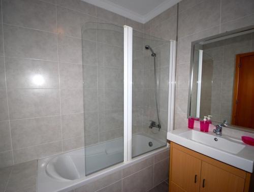 a bathroom with a shower and a tub and a sink at Alojamento Turistico in Maceira