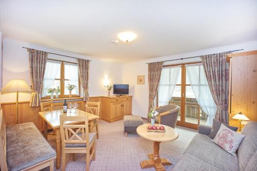 a living room with a couch and a table at Hotel Klosterhotel Ludwig der Bayer in Ettal