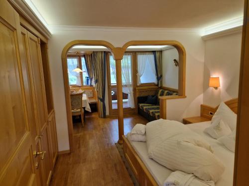 a hotel room with a bed and a mirror at Residence Ciastel in Ortisei