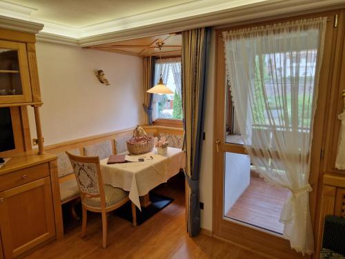 a dining room with a table and a window at Residence Ciastel in Ortisei