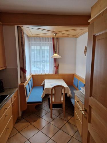a small kitchen with a table and a chair at Residence Ciastel in Ortisei