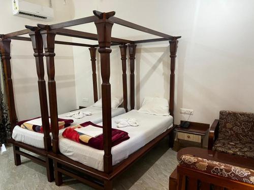 a bedroom with a four poster bed in a room at Maior Roma by Jolly Jolly Lester in Vagator