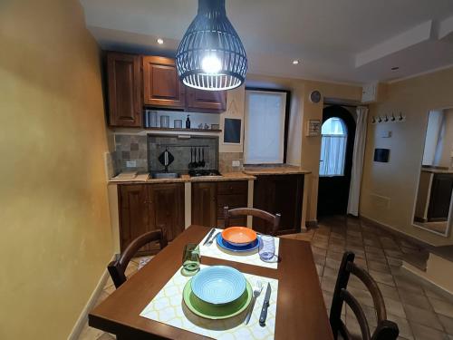 a kitchen with a wooden table and a dining room at Casa Vacanze Porta di Valle in Bagnoregio