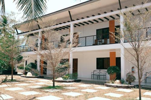 a building with trees in front of it at Maria Aliyah Events and Resort in Santa Cruz