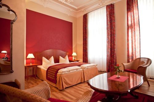 a bedroom with a bed with a red wall at Safestay Berlin Kurfurstendamm in Berlin