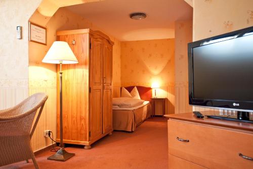 a bedroom with a bed and a flat screen tv at Safestay Berlin Kurfurstendamm in Berlin