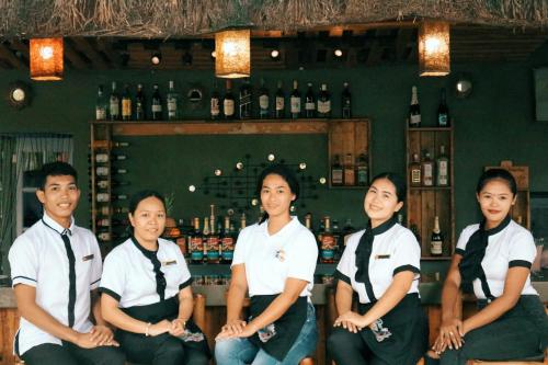 a group of people sitting in front of a bar at Maria Aliyah Events and Resort in Santa Cruz