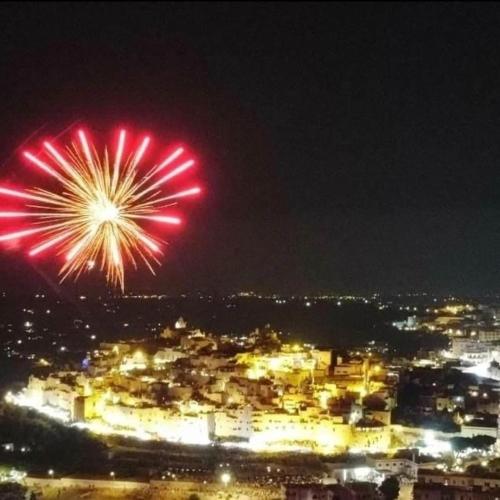 a fireworks display over a city at night at Casa Mirabilis 44 in Ostuni