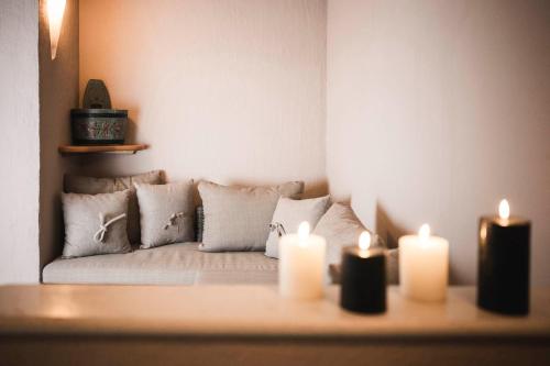 a living room with two candles on a couch at Hotel Cavallino D'Oro Bed&Breakfast in Castelrotto