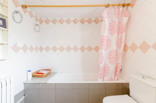 a bathroom with a toilet and a shower curtain at MASIA CAN SUNYER AGROTURISMO in La Garriga