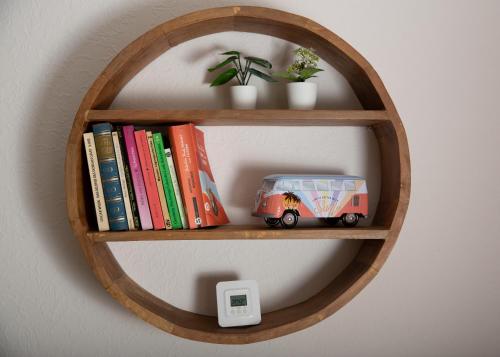 a book shelf with a toy van and books at Hotel Waldberg in Stolberg