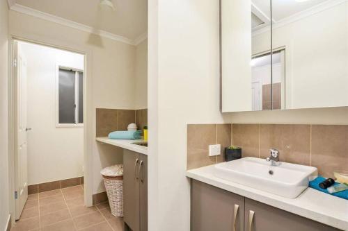 a bathroom with a sink and a mirror at Seaside Sanctuary Port Noarlunga in Port Noarlunga South